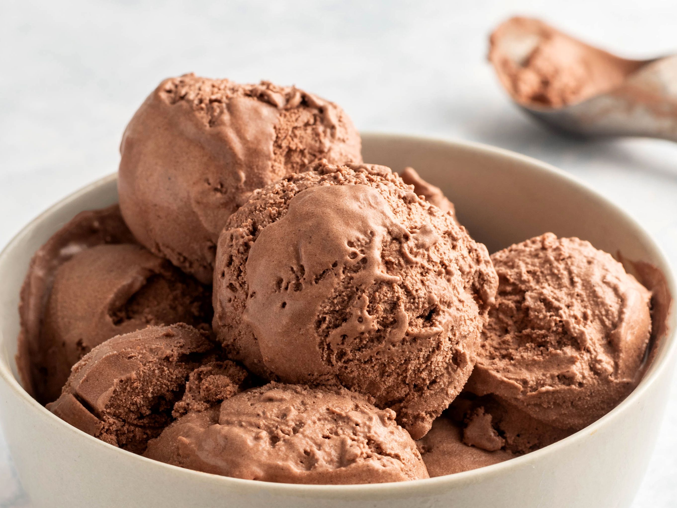 scoops of chocolate ice cream in white bowl